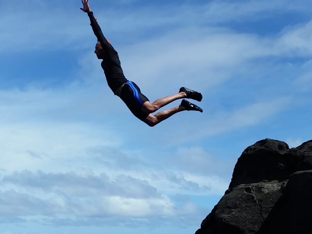 Kyle Banerjee jumping at Olivine pools